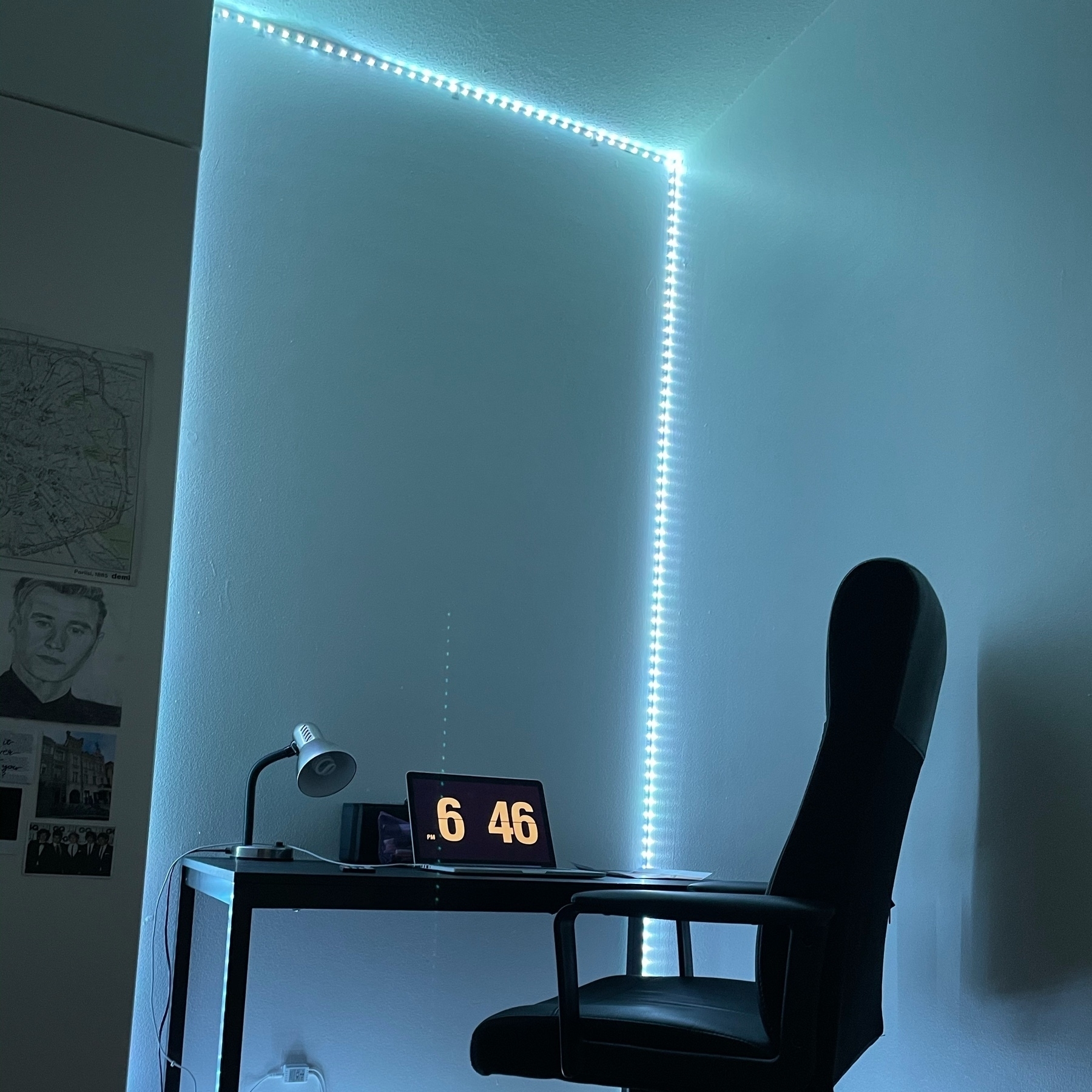 desk, laptop, desk lamp and an office chair in a led strip light