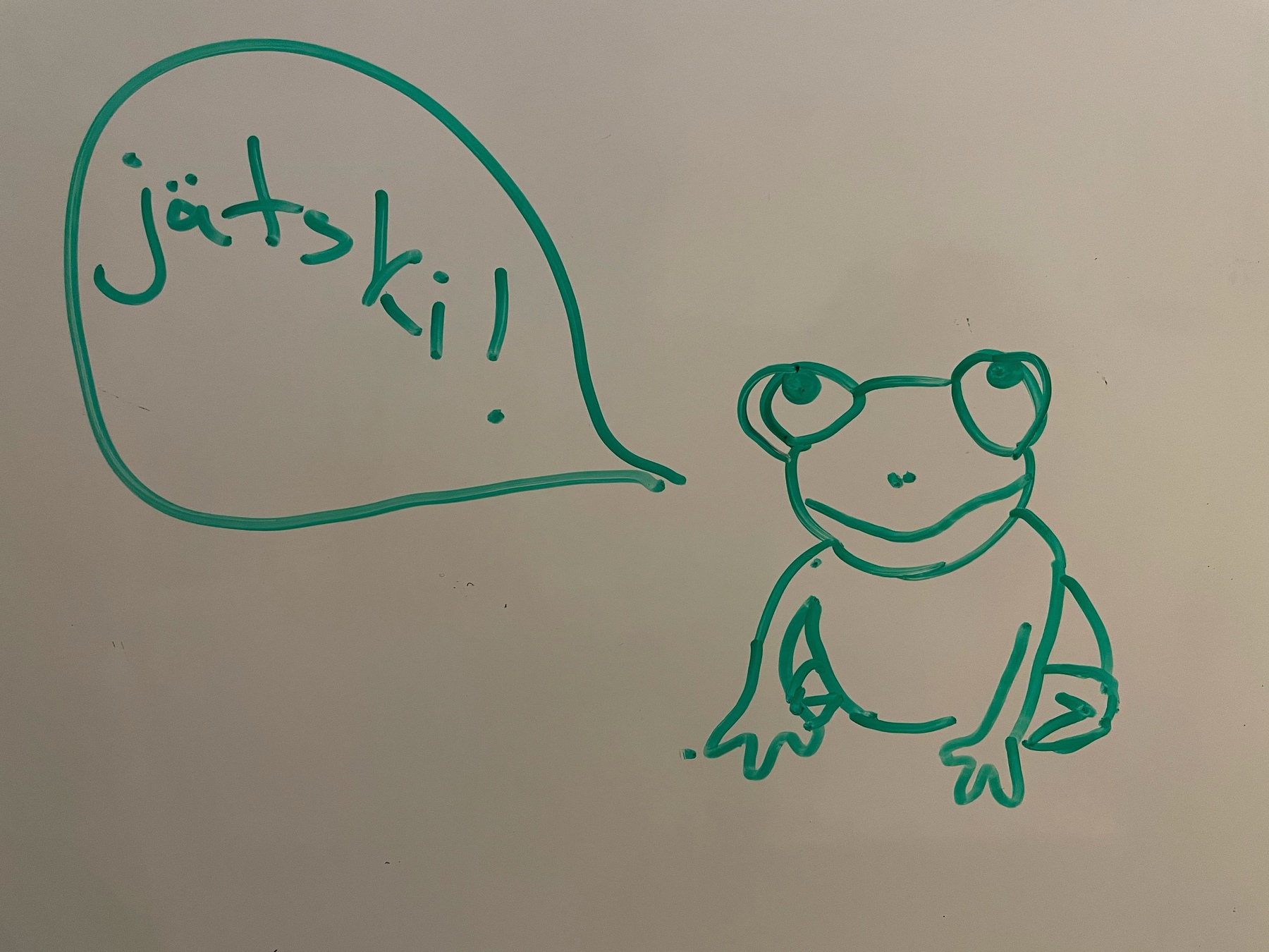 frog drawn on whiteboard, speech bubble saying "jätski" i.e. ice cream