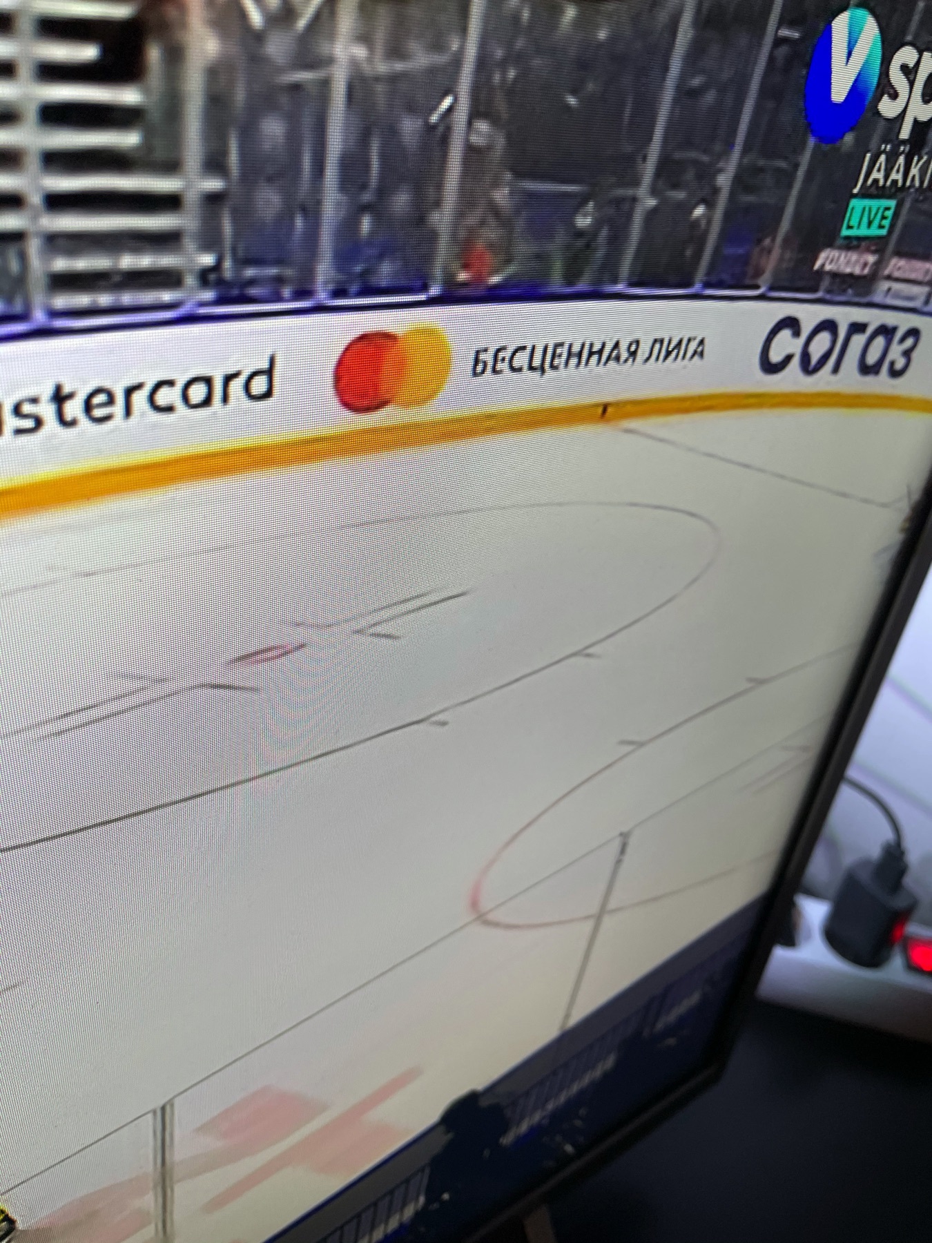 mastercard ad on the side of a hockey rink saying “priceless league” in Russian 