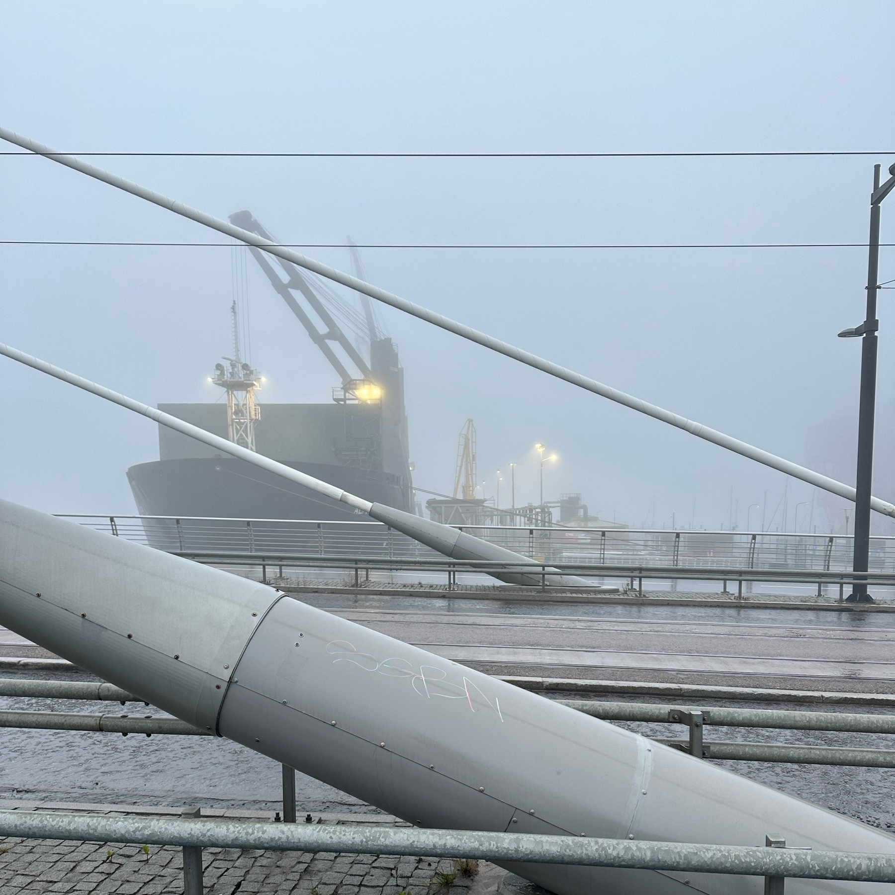 coal ship, suspension bridge pylons, fog