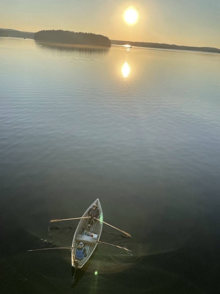 lake, setting sun and a boat