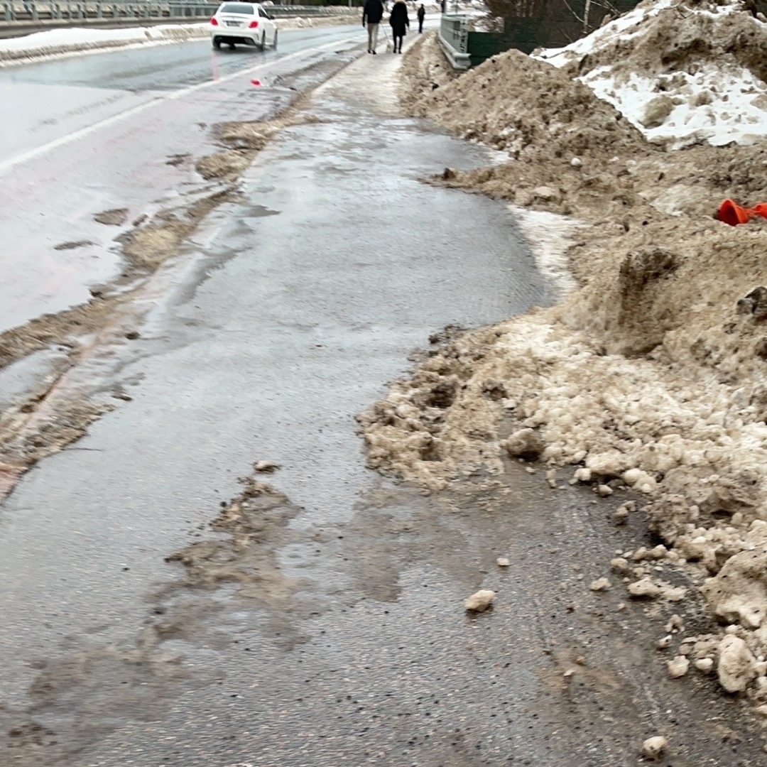 slush, wet asphalt, a puddle of water, some soft snow