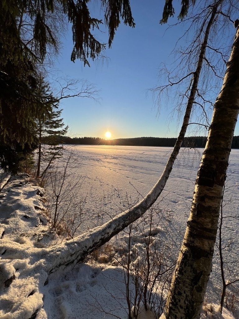winter sun laying low over a frozen lake